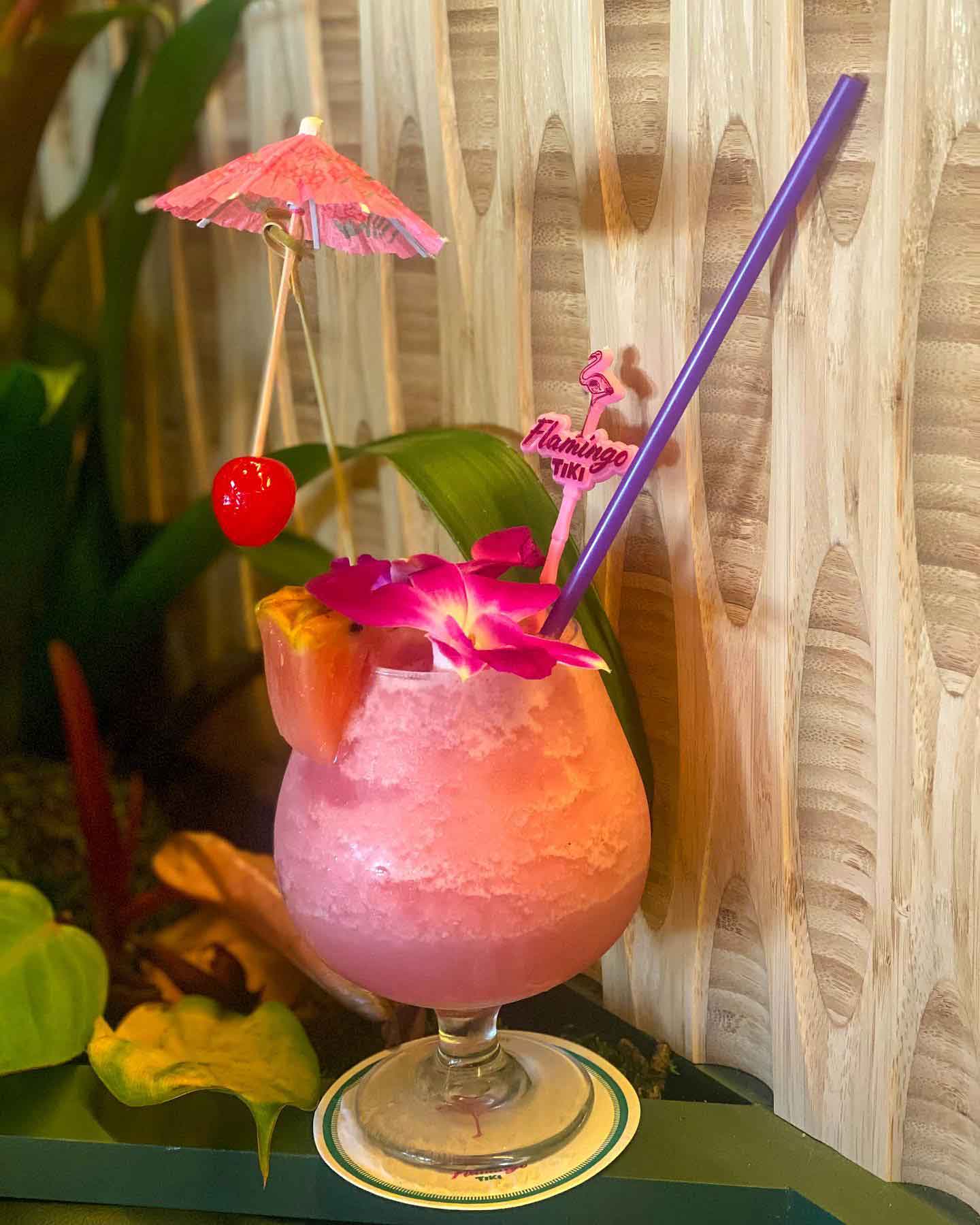 The Flamingo Cocktail with umbrella, flower, and pineapple slice